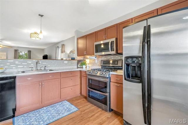 220 Preserve Park Pl, Wentzville, MO 63385 - kitchen featuring appliances with stainless steel finishes, light countertops, backsplash, and light wood-type flooring