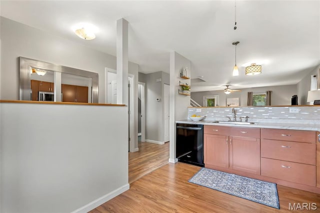 220 Preserve Park Pl, Wentzville, MO 63385 - kitchen with dishwasher, a ceiling fan, tasteful backsplash, stainless steel microwave, and light wood finished floors