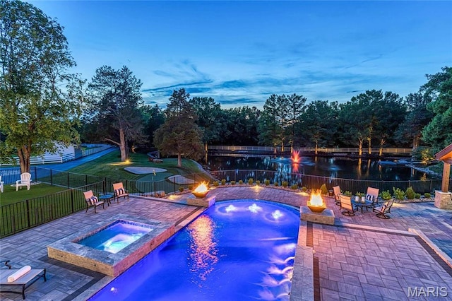 5425 Independence Rd, Weldon Spring, MO 63304 - pool at dusk featuring an outdoor fire pit, an in-ground hot tub, and a patio