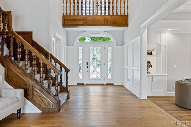 5425 Independence Rd, Weldon Spring, MO 63304 - foyer entrance featuring a high ceiling, stairs, light wood-style floors, and a decorative wall