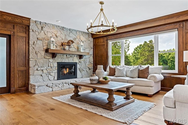 5425 Independence Rd, Weldon Spring, MO 63304 - living area featuring a chandelier, a fireplace, and light wood finished floors