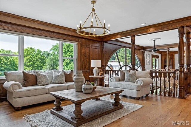 5425 Independence Rd, Weldon Spring, MO 63304 - living room with a chandelier, ornamental molding, wood walls, and light wood finished floors