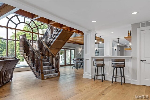5425 Independence Rd, Weldon Spring, MO 63304 - stairs with a decorative wall, wood finished floors, ornate columns, beamed ceiling, and recessed lighting