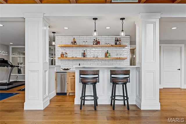 5425 Independence Rd, Weldon Spring, MO 63304 - indoor wet bar with decorative columns, light wood-style floors, tasteful backsplash, decorative light fixtures, and recessed lighting