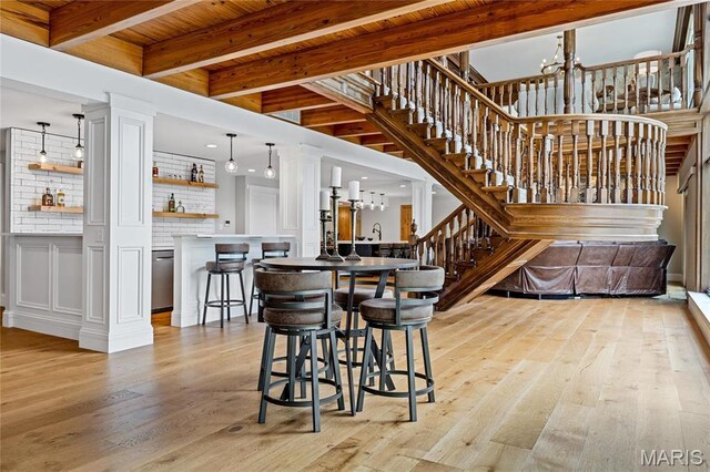 5425 Independence Rd, Weldon Spring, MO 63304 - dining space featuring light wood-style flooring, stairway, decorative columns, a chandelier, and wood ceiling with exposed beams