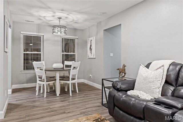 5425 Independence Rd, Weldon Spring, MO 63304 - dining room with light wood-type flooring, baseboards, and a chandelier