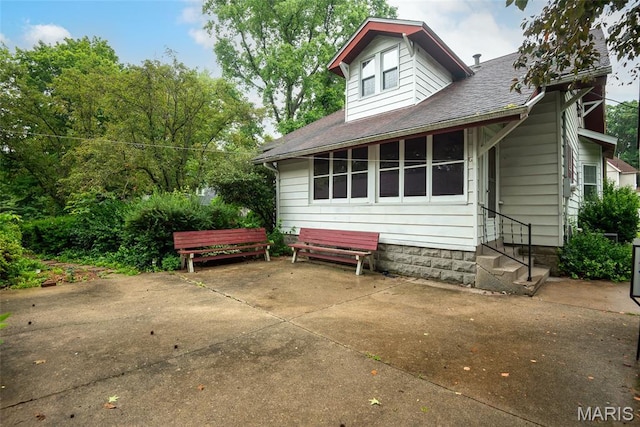 148 N Nebraska St, Marine, IL 62061 - back of property featuring entry steps, a patio area, and roof with shingles