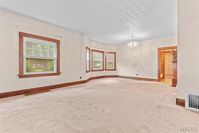 148 N Nebraska St, Marine, IL 62061 - carpeted spare room with a chandelier, baseboards, and a textured ceiling