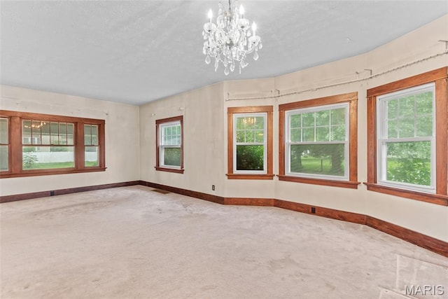 148 N Nebraska St, Marine, IL 62061 - carpeted spare room with baseboards, a chandelier, and a textured ceiling