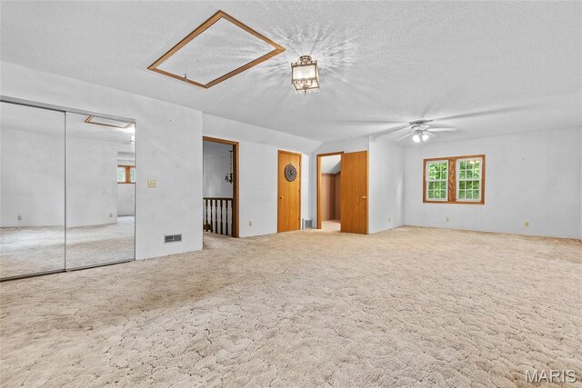 148 N Nebraska St, Marine, IL 62061 - unfurnished living room featuring attic access, carpet, a ceiling fan, and a textured ceiling