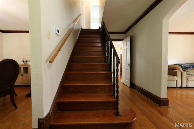 7530 Forest View Dr, Pasadena Park, MO 63121 - staircase featuring ornamental molding, wood finished floors, and arched walkways