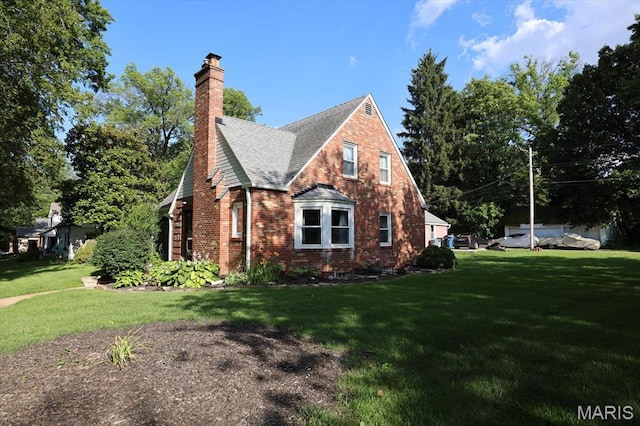 7530 Forest View Dr, Pasadena Park, MO 63121 - view of home's exterior with a lawn, roof with shingles, brick siding, and a chimney