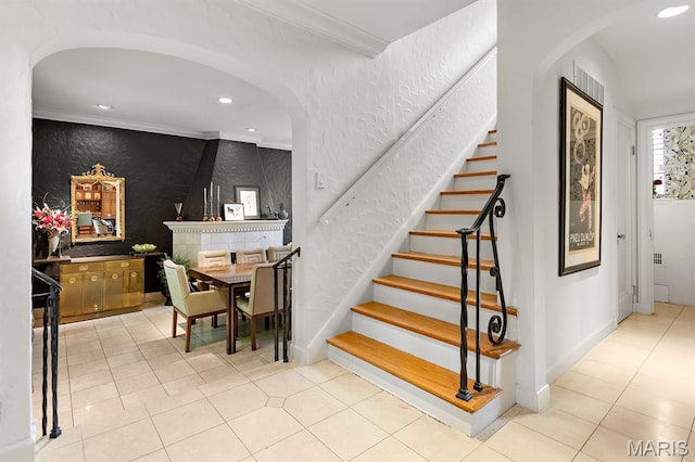 7428 Wellington Way, Clayton, MO 63105 - stairway featuring arched walkways, tile patterned flooring, recessed lighting, crown molding, and a textured wall