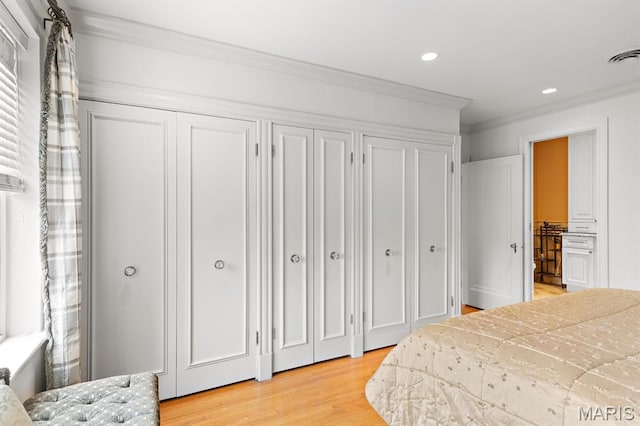 7428 Wellington Way, Clayton, MO 63105 - bedroom featuring multiple closets, light wood-style flooring, ornamental molding, and recessed lighting