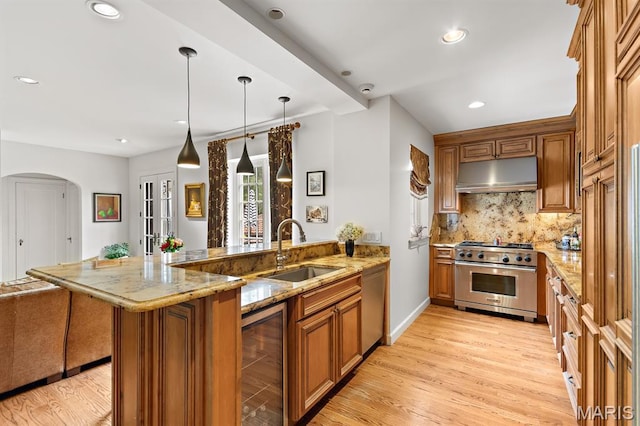 7428 Wellington Way, Clayton, MO 63105 - kitchen featuring stainless steel appliances, under cabinet range hood, a sink, wine cooler, and brown cabinetry