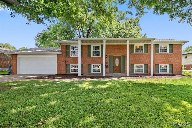 2604 Headland Dr, Saint Charles, MO 63301 - split foyer home featuring a front lawn, an attached garage, concrete driveway, and brick siding