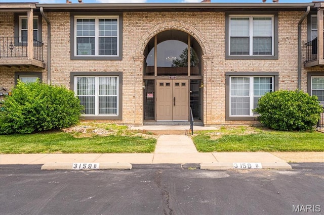 3159 Carefree Ln Unit B, Florissant, MO 63033 - view of front of home with uncovered parking and brick siding