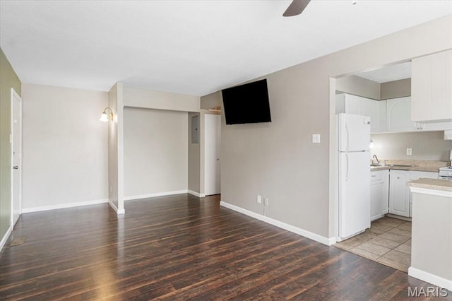3159 Carefree Ln Unit B, Florissant, MO 63033 - unfurnished living room with light wood-style flooring, a ceiling fan, and baseboards