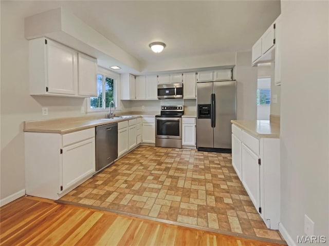 313 Pralle Ln, Saint Charles, MO 63303 - kitchen featuring appliances with stainless steel finishes, light countertops, and white cabinets
