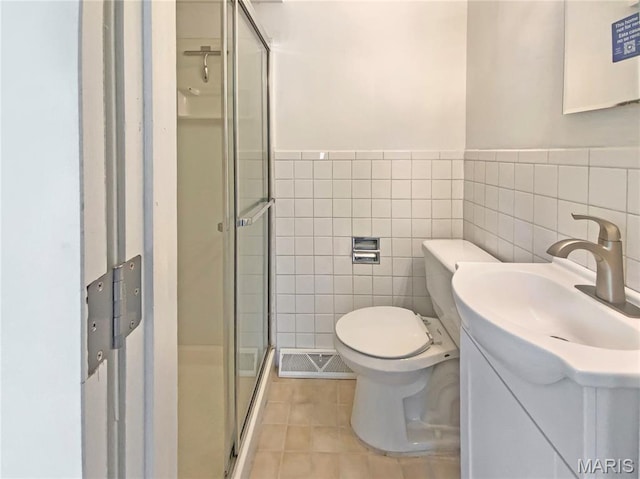 313 Pralle Ln, Saint Charles, MO 63303 - bathroom featuring a shower stall, tile patterned flooring, tile walls, vanity, and toilet