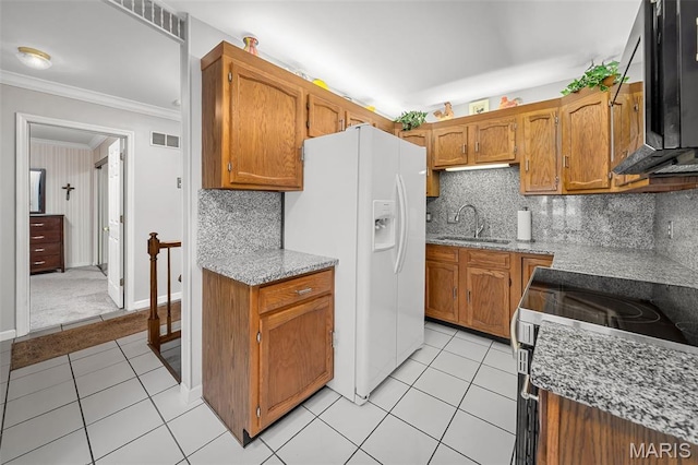 1615 Rosewall Dr Unit C, Saint Charles, MO 63303 - kitchen with white refrigerator with ice dispenser, ornamental molding, stainless steel range with electric stovetop, brown cabinets, and light tile patterned flooring