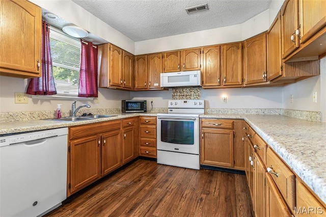 1121 N Desloge Dr Unit J-2, Desloge, MO 63601 - kitchen featuring white appliances, a sink, a textured ceiling, dark wood-style flooring, and brown cabinets