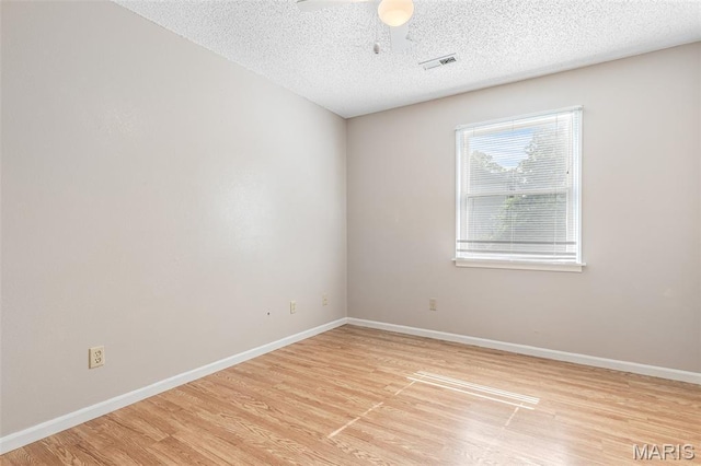 1121 N Desloge Dr Unit J-2, Desloge, MO 63601 - spare room featuring light wood-style floors, a textured ceiling, baseboards, and a ceiling fan