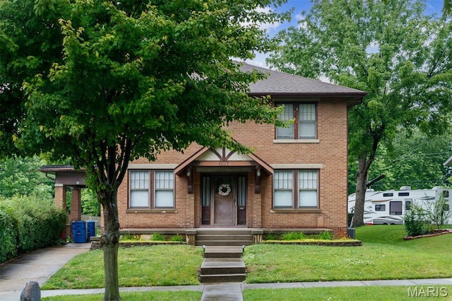 607 9th St, Highland, IL 62249 - view of front of house featuring brick siding and a front lawn