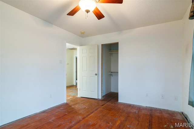 607 9th St, Highland, IL 62249 - unfurnished bedroom featuring wood-type flooring, a closet, and a ceiling fan