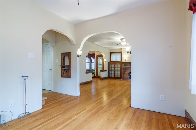 607 9th St, Highland, IL 62249 - spare room with arched walkways, light wood-type flooring, and ceiling fan