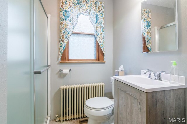 607 9th St, Highland, IL 62249 - full bathroom featuring radiator heating unit, a stall shower, toilet, and vanity