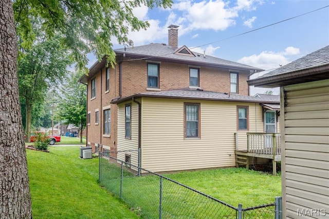 607 9th St, Highland, IL 62249 - rear view of property with a chimney, cooling unit, and brick siding