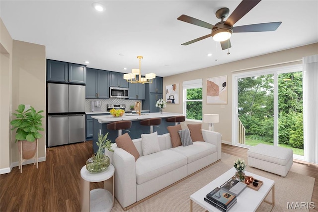 357 Newbridge Way, Ofallon, MO 63368 - living room with a chandelier, dark wood-type flooring, recessed lighting, baseboards, and ceiling fan