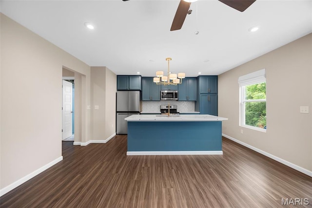 357 Newbridge Way, Ofallon, MO 63368 - kitchen with stainless steel appliances, a chandelier, dark wood-style flooring, baseboards, and a center island with sink