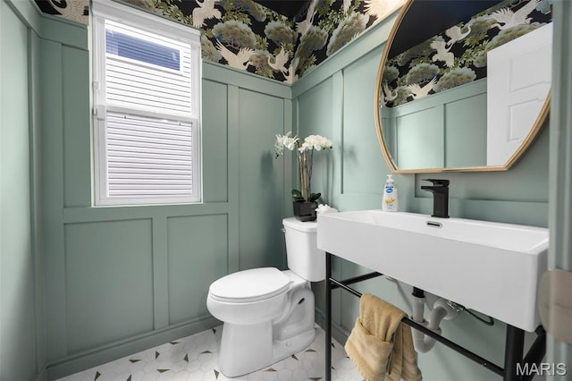 357 Newbridge Way, Ofallon, MO 63368 - half bath with a decorative wall, toilet, a sink, and wainscoting