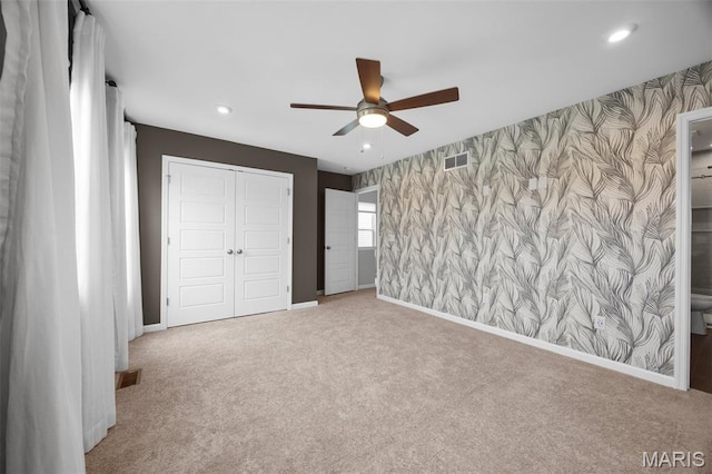 357 Newbridge Way, Ofallon, MO 63368 - unfurnished bedroom featuring wallpapered walls, an accent wall, carpet floors, recessed lighting, and a closet