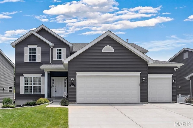 5034 Corisande Woods Dr, Fenton, MO 63026 - traditional home with an attached garage, concrete driveway, and a front lawn