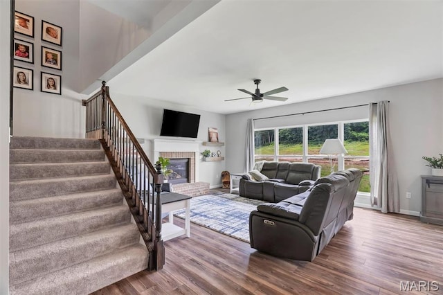 5034 Corisande Woods Dr, Fenton, MO 63026 - living area with a ceiling fan, stairway, wood finished floors, and a fireplace