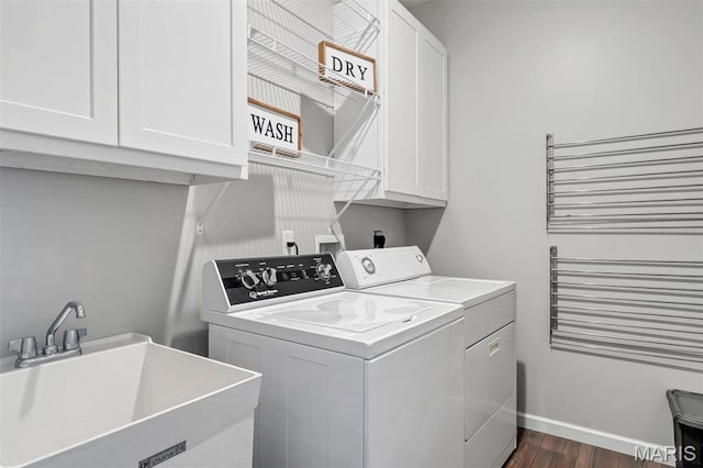 5034 Corisande Woods Dr, Fenton, MO 63026 - laundry area featuring cabinet space, independent washer and dryer, and dark wood finished floors