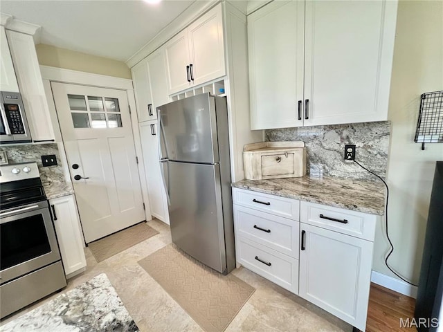 873 White Rd, Montgomery City, MO 63361 - kitchen with appliances with stainless steel finishes, decorative backsplash, white cabinetry, and light stone countertops