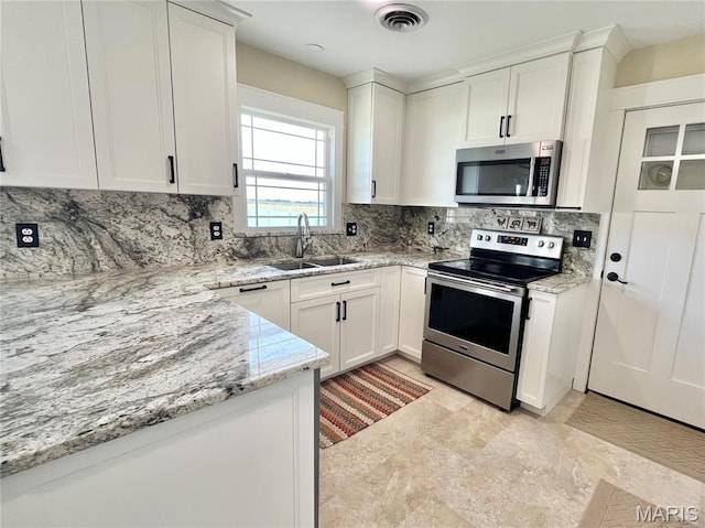 873 White Rd, Montgomery City, MO 63361 - kitchen featuring stainless steel appliances, backsplash, white cabinets, and light stone counters