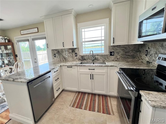 873 White Rd, Montgomery City, MO 63361 - kitchen featuring stainless steel appliances, a peninsula, white cabinets, and tasteful backsplash