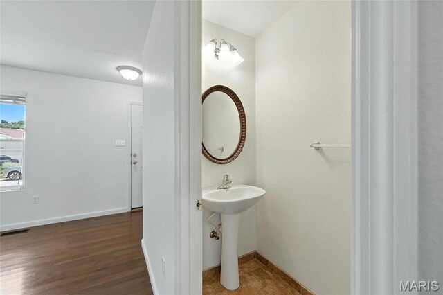 429 Red Coat Trl, Wentzville, MO 63385 - bathroom with baseboards and wood finished floors