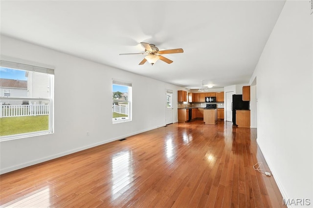 429 Red Coat Trl, Wentzville, MO 63385 - unfurnished living room with a ceiling fan and wood finished floors