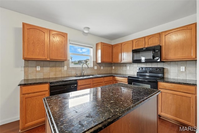 429 Red Coat Trl, Wentzville, MO 63385 - kitchen with black appliances, dark wood-type flooring, dark stone counters, and a kitchen island