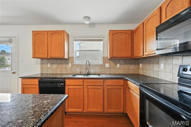 429 Red Coat Trl, Wentzville, MO 63385 - kitchen featuring black appliances, dark wood-style flooring, dark stone countertops, and tasteful backsplash