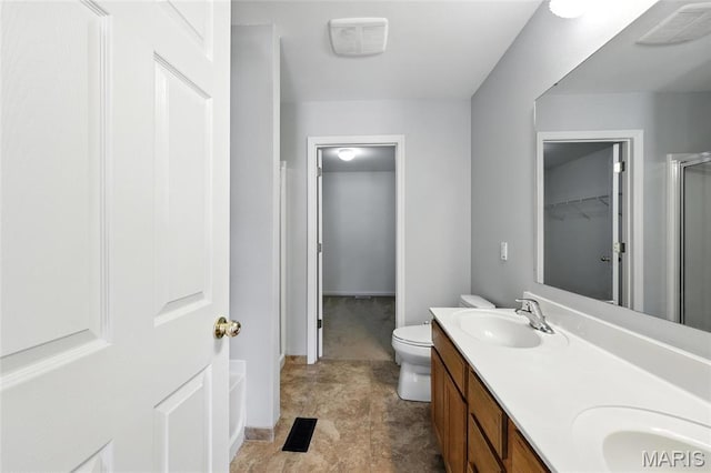 429 Red Coat Trl, Wentzville, MO 63385 - bathroom featuring double vanity, a shower stall, and a walk in closet