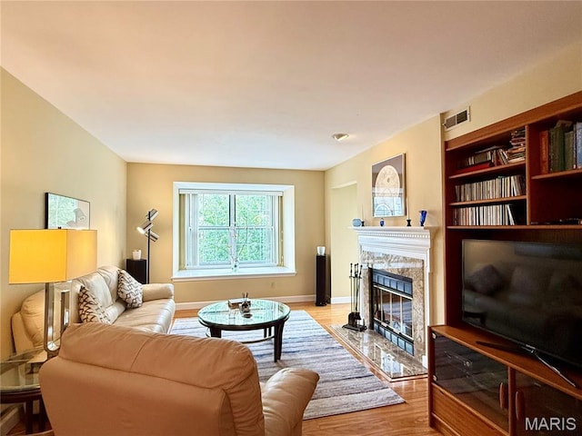 4235 W Pine Blvd Unit 21, Saint Louis, MO 63108 - living area with light wood finished floors, a fireplace, and baseboards