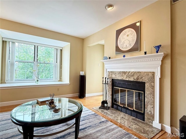4235 W Pine Blvd Unit 21, Saint Louis, MO 63108 - living area with a fireplace, baseboards, and wood finished floors