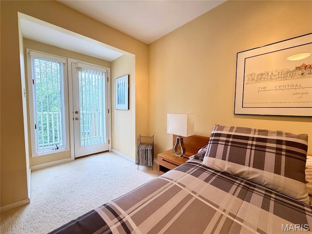 4235 W Pine Blvd Unit 21, Saint Louis, MO 63108 - bedroom with access to exterior, carpet flooring, and baseboards